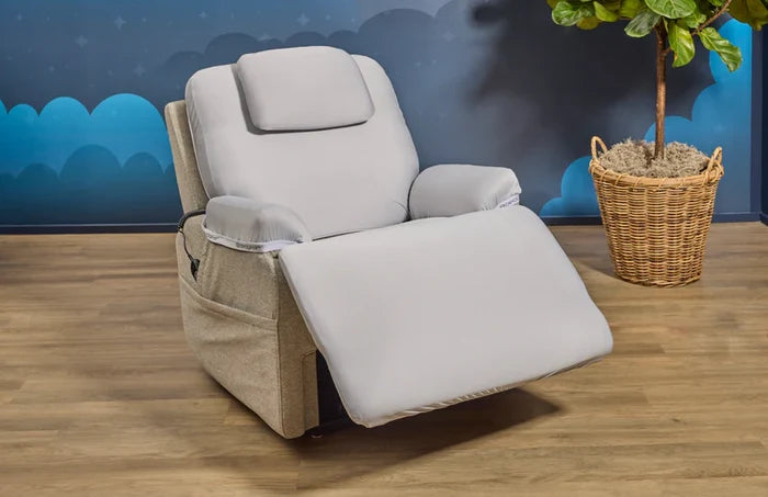 Light gray reclining chair with footrest extended and cushioned seat and back.